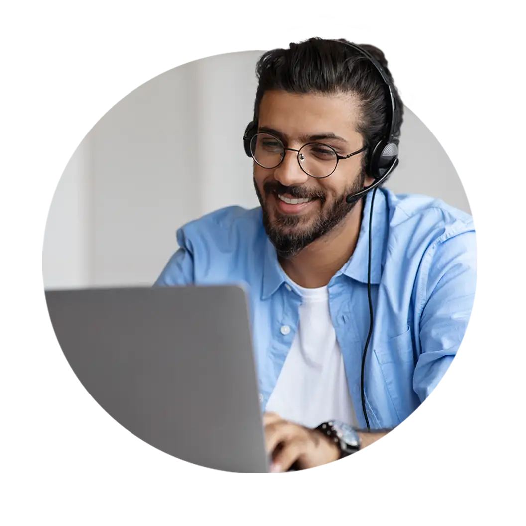 A circular image of a technical support representative wearing a headset and using a computer while smiling